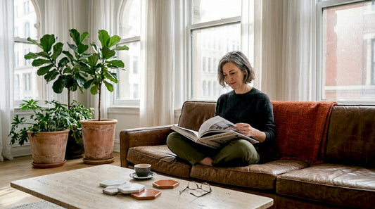 Frau liest ein Buch über Inneneinrichtung in einem italienischen Wohnzimmer
