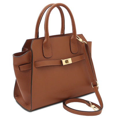 Brown leather handbag with gold hardware on a white background