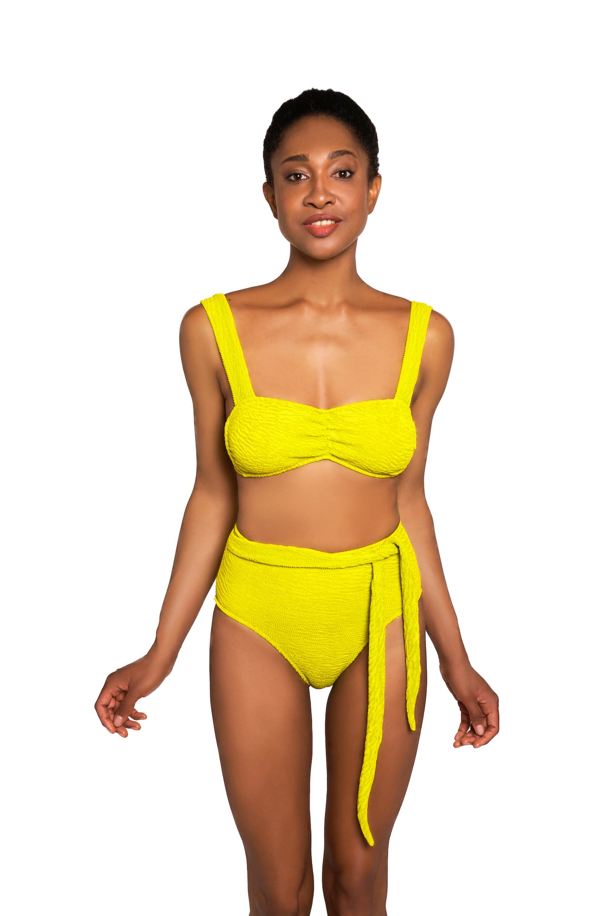 Woman wearing a bright yellow bikini set on a white background