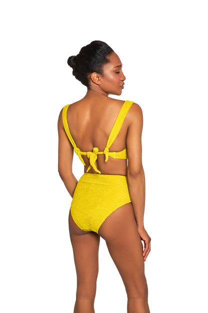 Woman wearing a yellow swimsuit on a white background