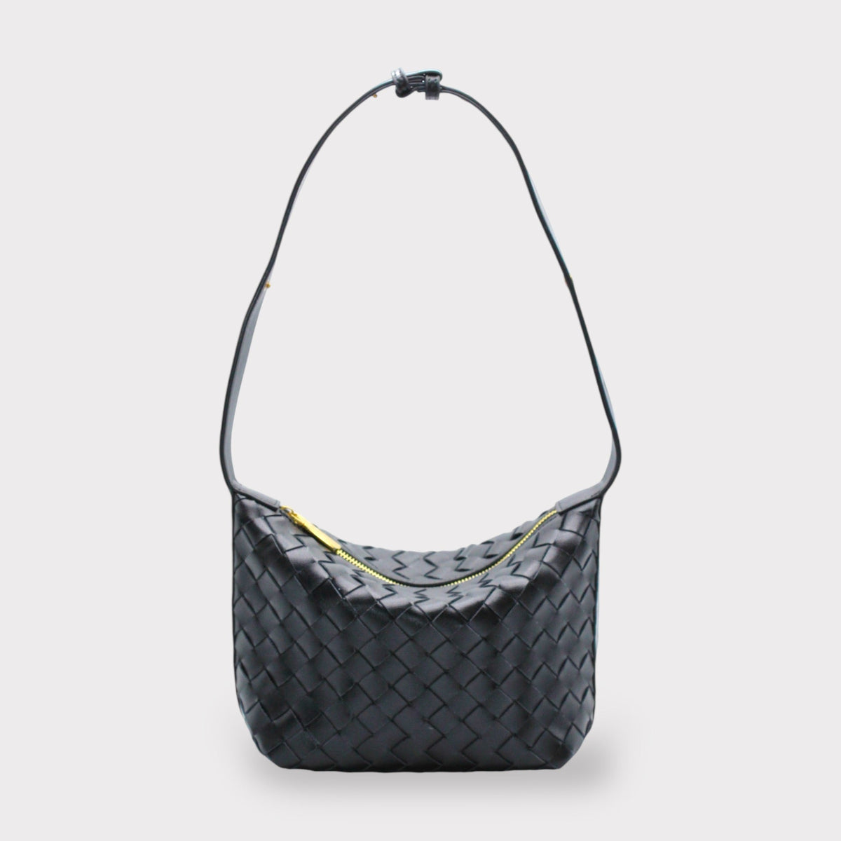 Black woven leather shoulder bag with a long strap and gold zipper.