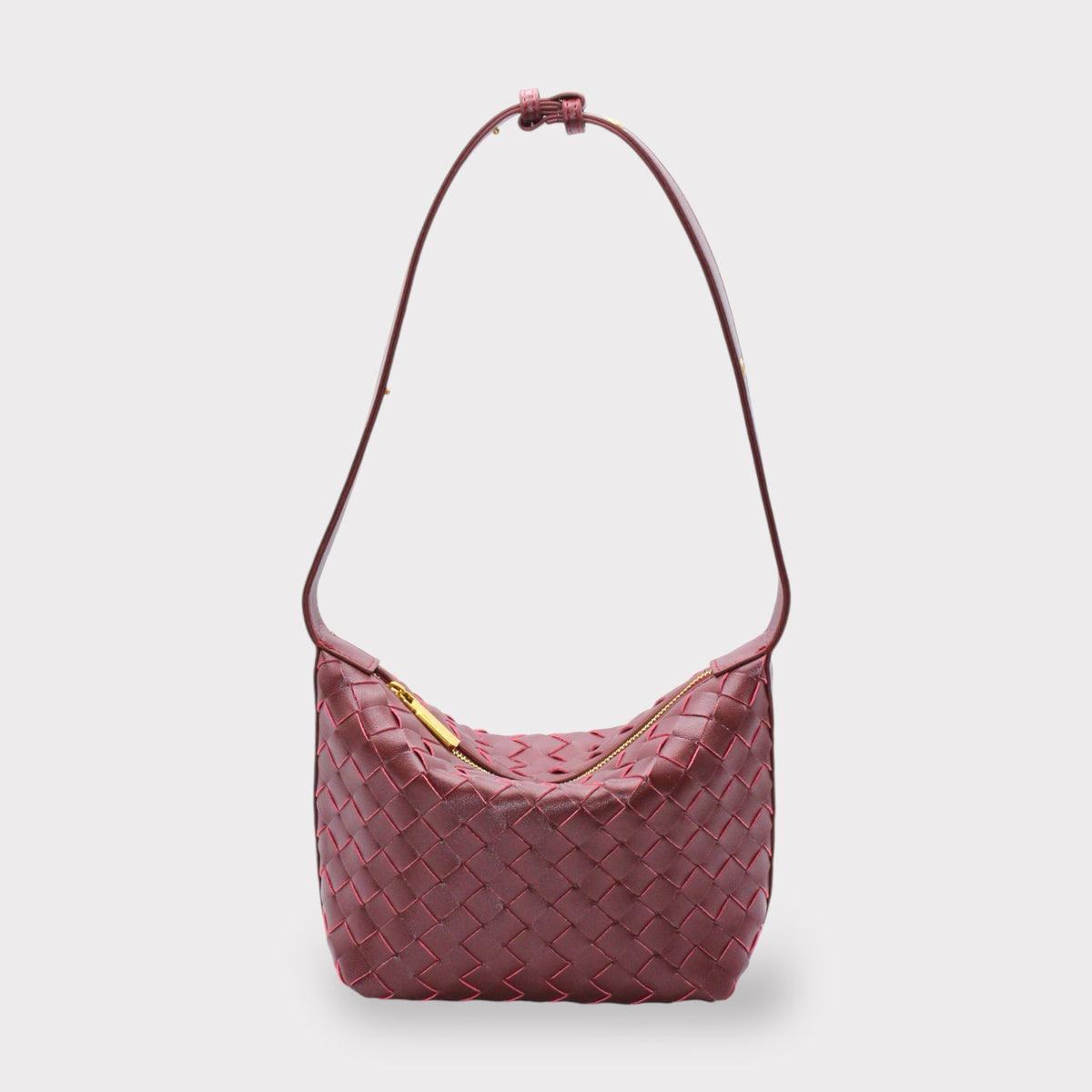 Genuine leather woven style boxed pouch bag in burgundy with a gold zipper and long shoulder strap