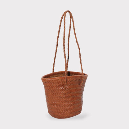 Carmel hand woven brown leather shoulder bucket bag shown in zijaanzicht with braided handles.