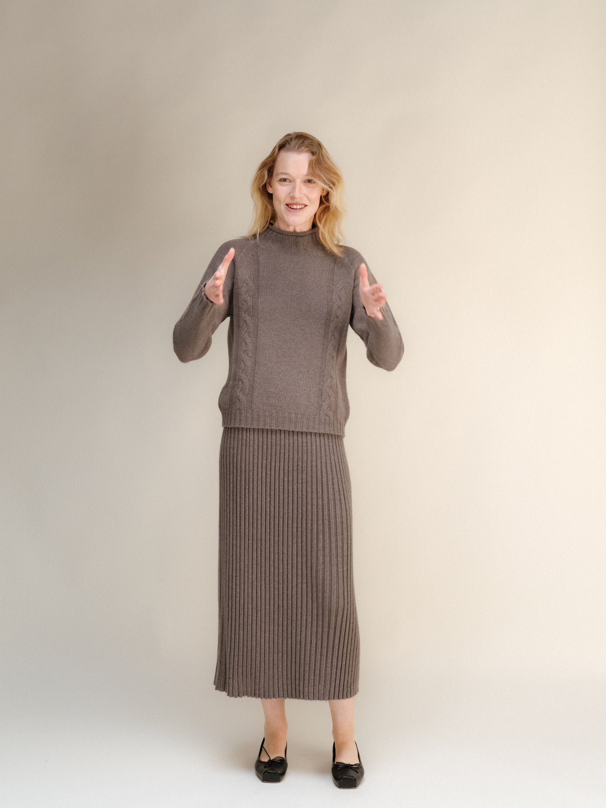 Modelo con a taupe cashmere blend knit sweater and matching falda larga acanalada.