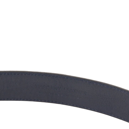Close-up of navy suede belt showing stitched edge and subtle embossed text on the strap