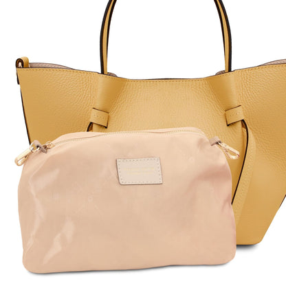 Vista frontale of Legame small yellow leather hebag con beige trim e a beige pouch inside.