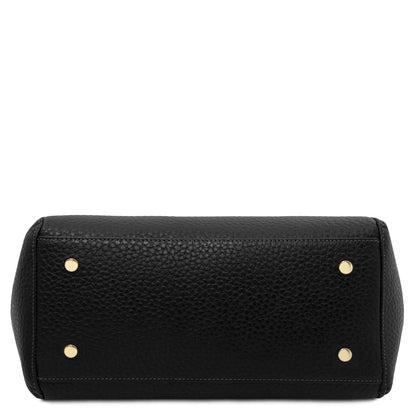 Bottom view of black pebbled leather tote bag with four gold feet