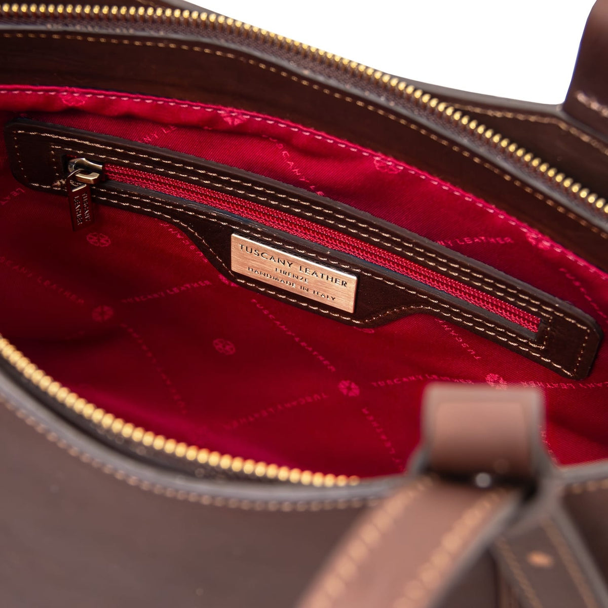 Inside of Libra long handle leather tote bag with red lining and zip pocket