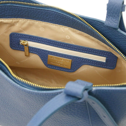 Interior view of blue Libra long handle leather tote with beige lining and gold logo plaque