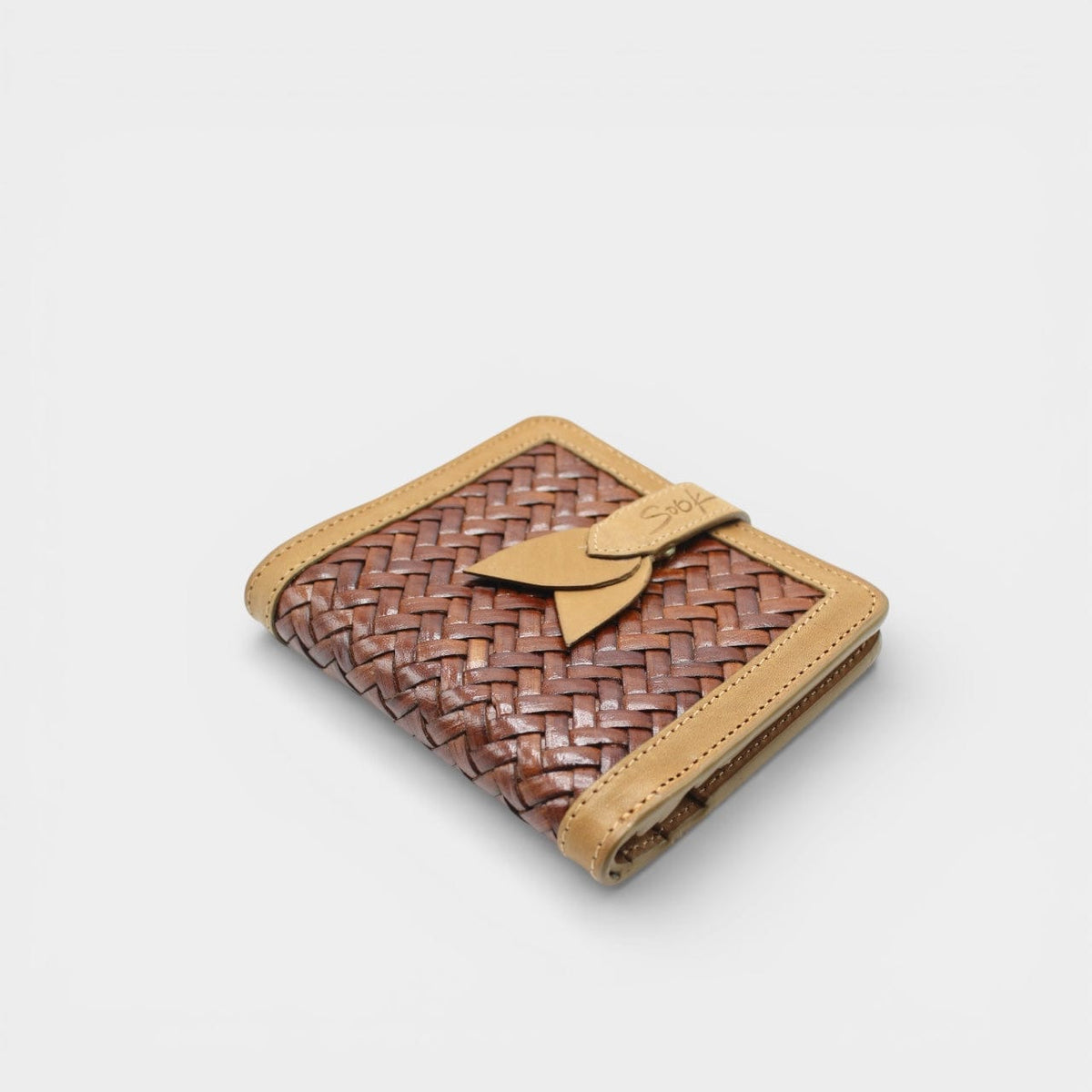 Lumi - Handwoven Leather Wallet | Taupe & Kaffee featuring woven coffee leather with smooth taupe trim and decorative tab closure on plain surface.