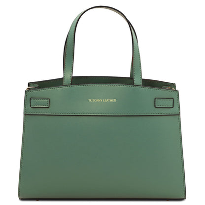 Green leather handbag with 'Tuscany Leather' branding on a white background