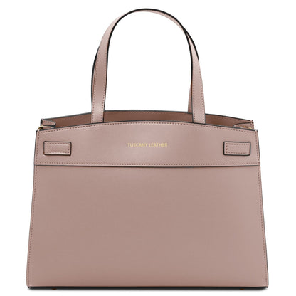 Nude pink handbag with 'Tuscany Leather' branding on a white background
