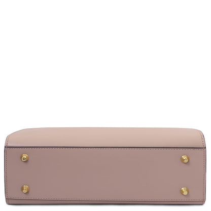 Bottom view of a blush pink Musa Italian leather handbag showing gold feet.