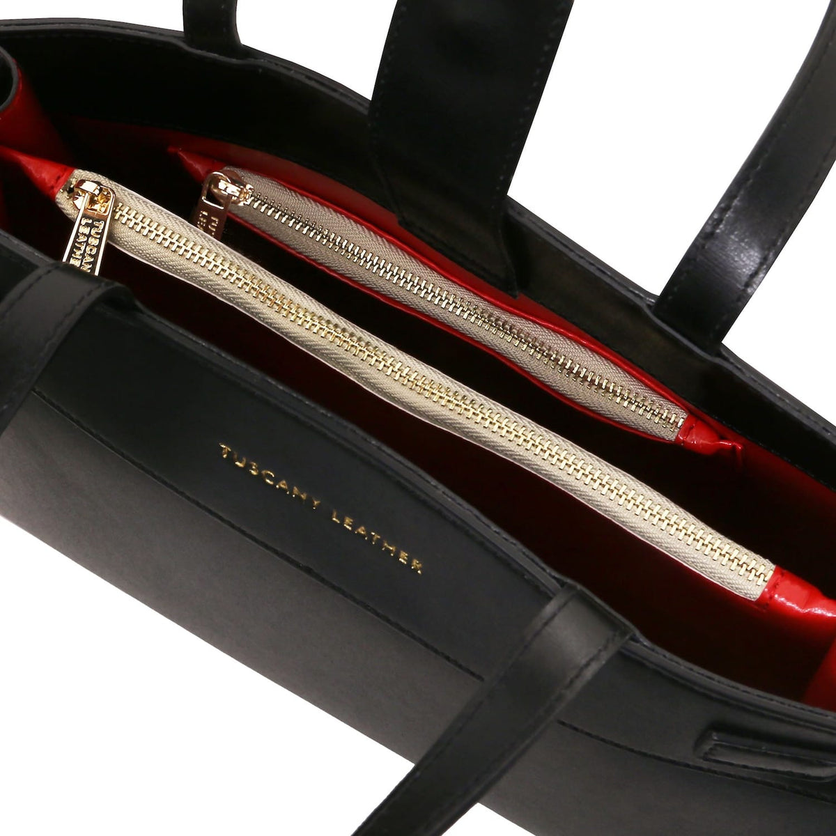 Interior view of Musa Italian leather handbag with red lining and gold zip compartments