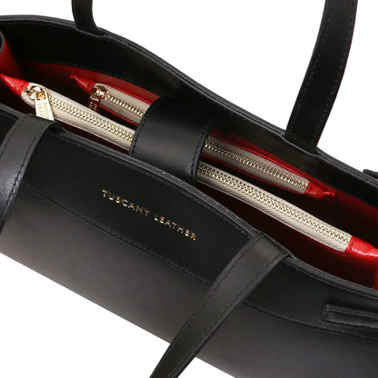 Interior of Musa handbag with red lining and gold zippers and organized compartments