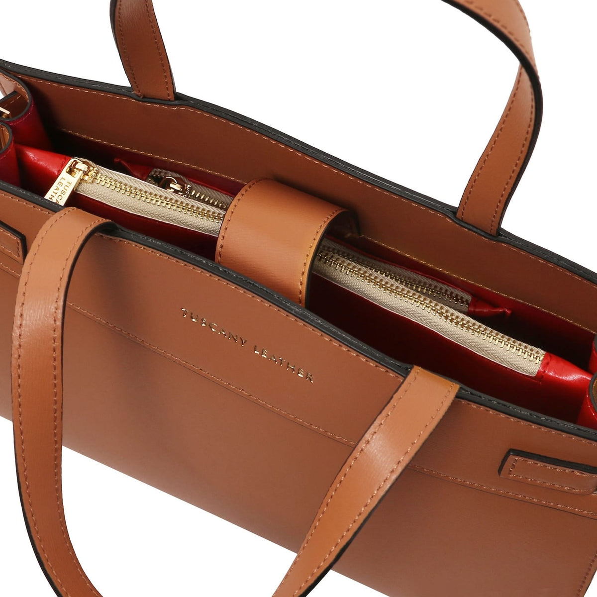 Interior of Musa handbag with gold zipper pocket and red lining.