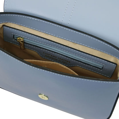 Inside view of Nausica bag showing beige lining and a blue zip pocket with gold pull