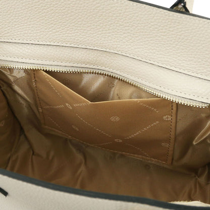 Interior of beige leather tote with tan lining and a zippered pocket