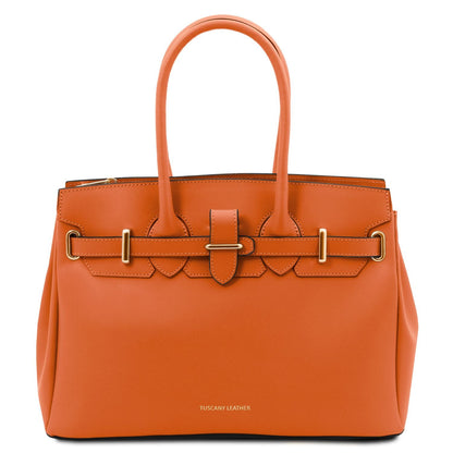 Orange handbag with gold hardware on a white background