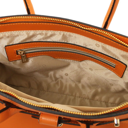 Interior view of orange leather handbag with beige patterned lining and an inner zippered pocket with gold-tone zipper pull.