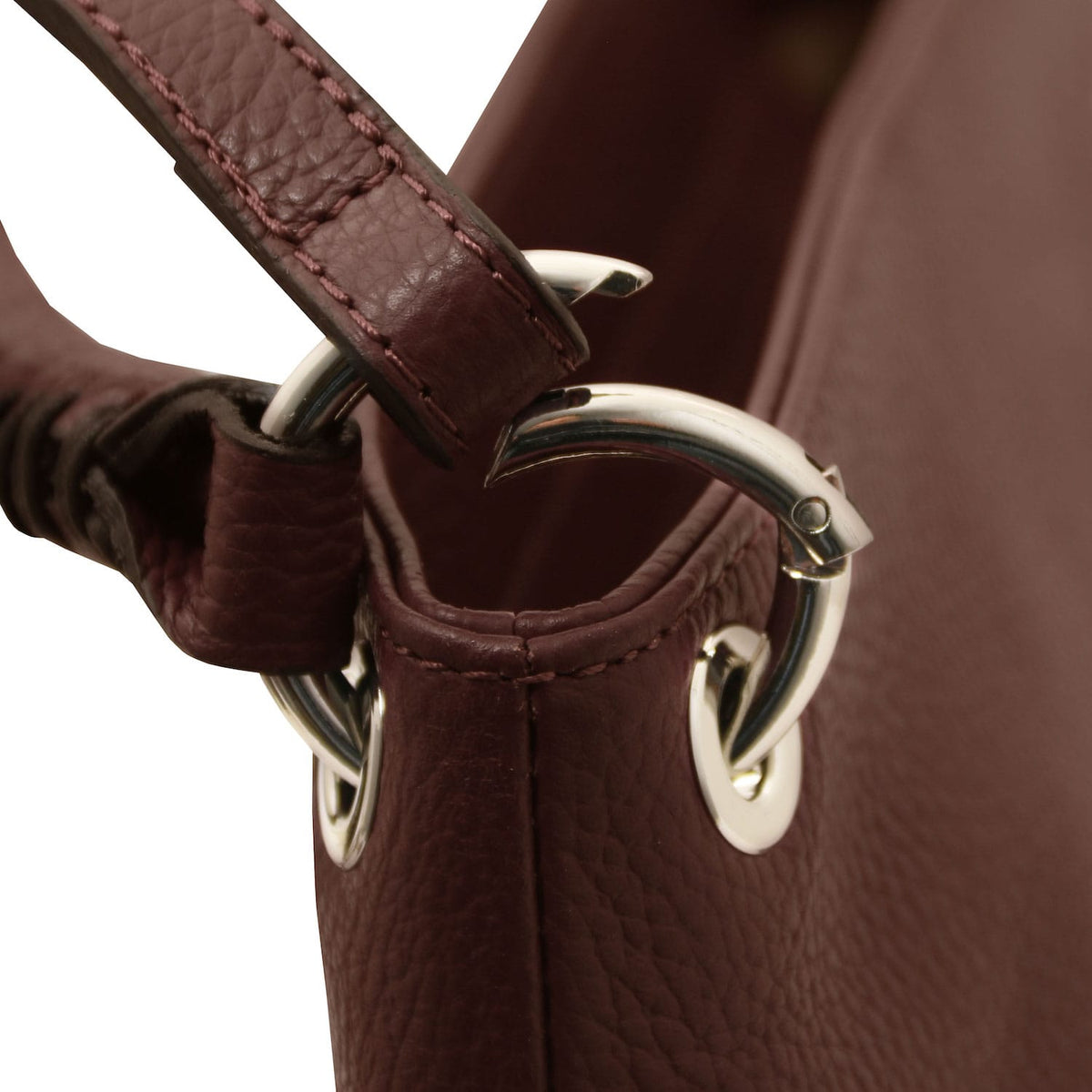 TL Bag - Soft Italian leather handbag | TL142087 in deep burgundy pebbled leather with silver hardware close-up on strap attachment.