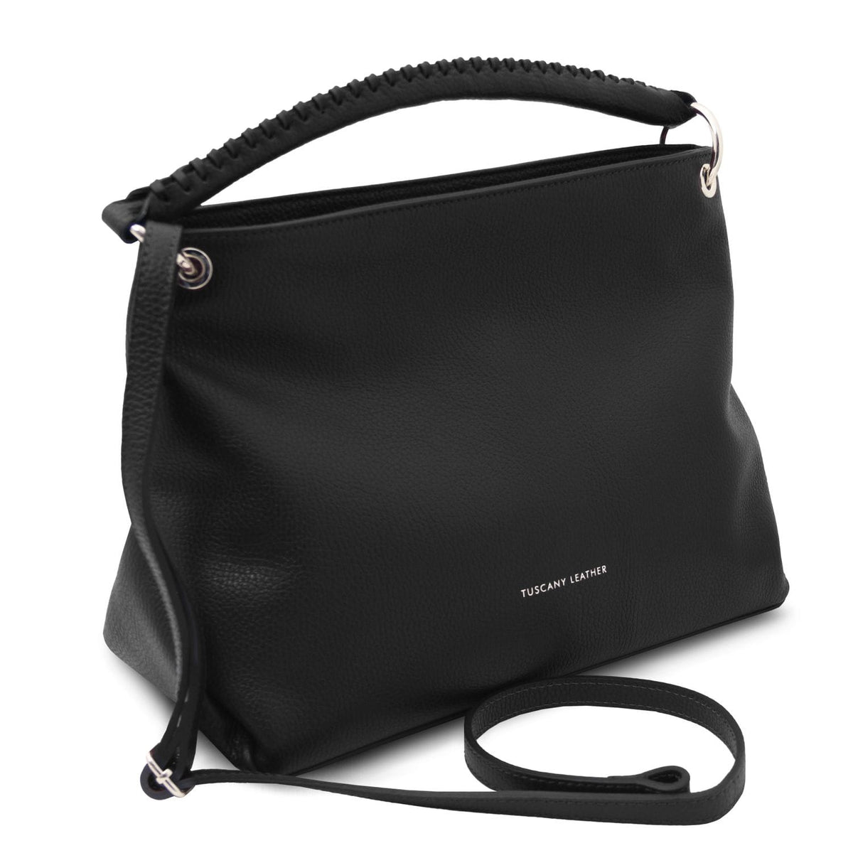 Black TL Bag shown from side with curved top edge and long crossbody strap laid in front.