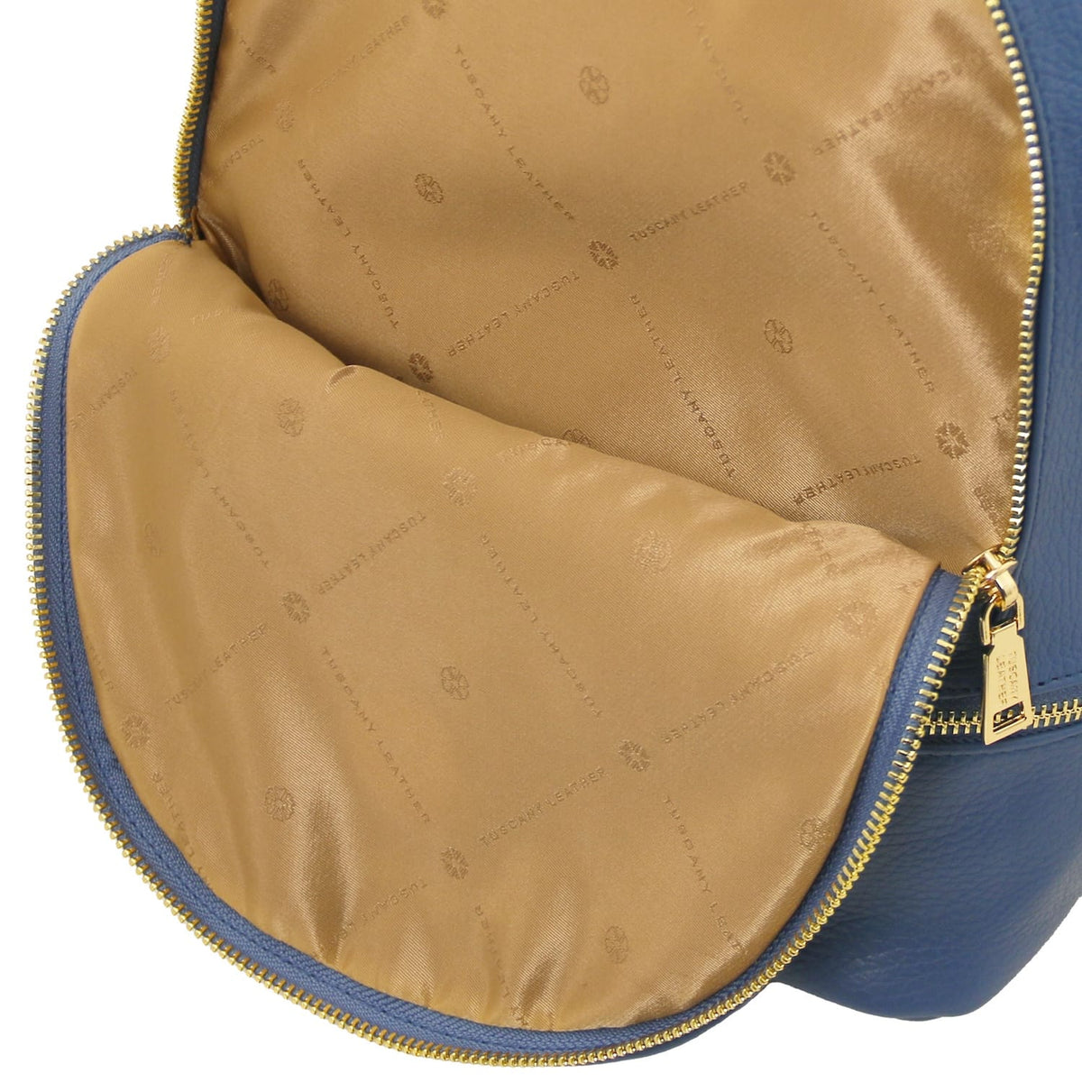 Inside view of TL Bag showing tan patterned lining and edge zipper with gold hardware.