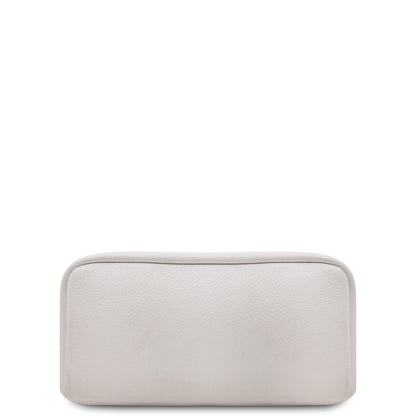 Bottom close-up of white leather backpack with a gold zipper and tan interior lining