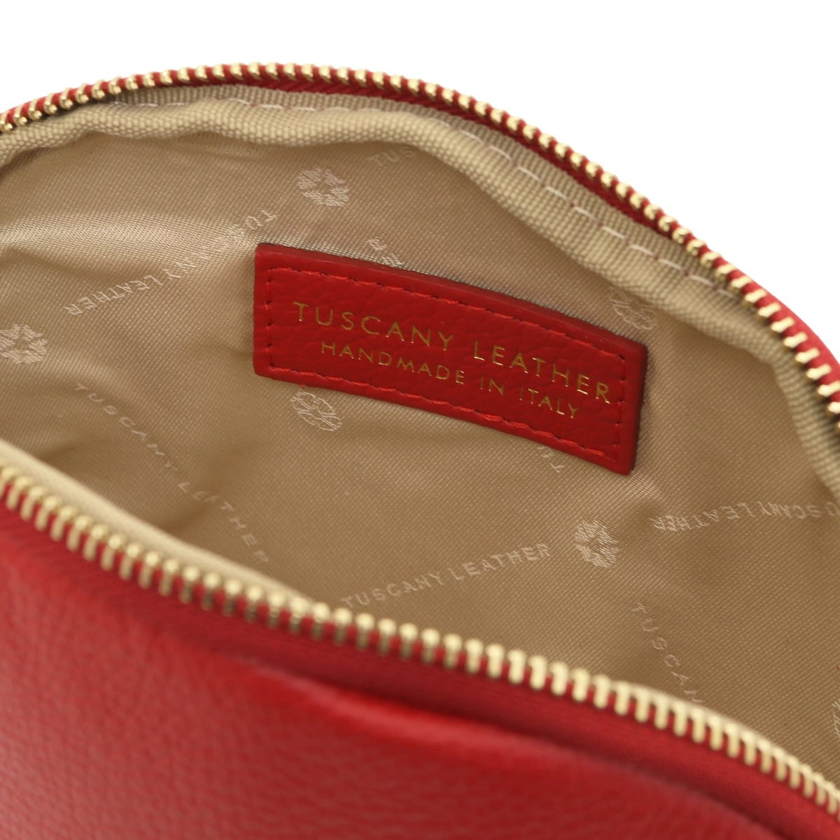 Rosso Vera leather toiletry case opened to reveal fodera beige e a hemade in Italy label.